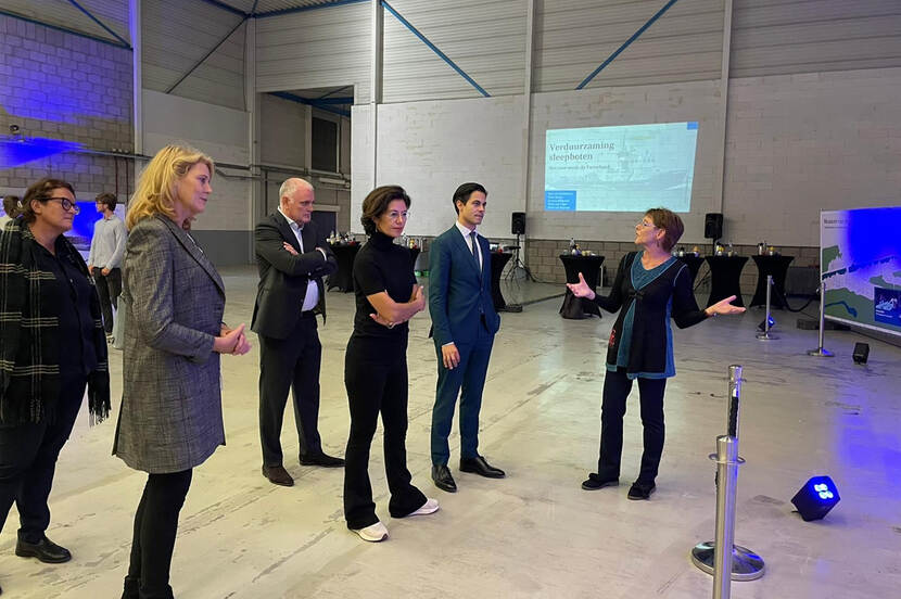 Staatssecretaris Uslu en minister Jetten staan in een Loods, waar zij uitleg krijgen over het project Stadshaven Maassluis